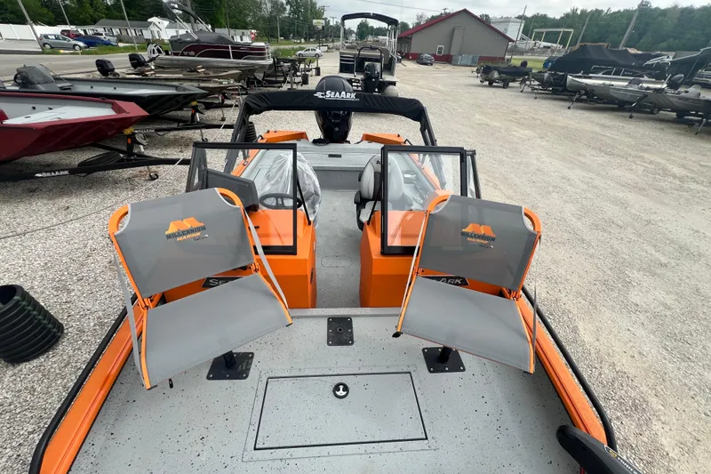 Slide: The Image of 2025 SeaArk ProCat 200 boat in vibrant orange, displayed on a trailer with a dynamic water backdrop. - 6
