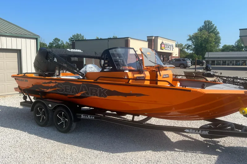 Slide: The Image of 2026 SeaArk ProCat 200 boat, orange exterior, on a trailer in a parking lot. - 7