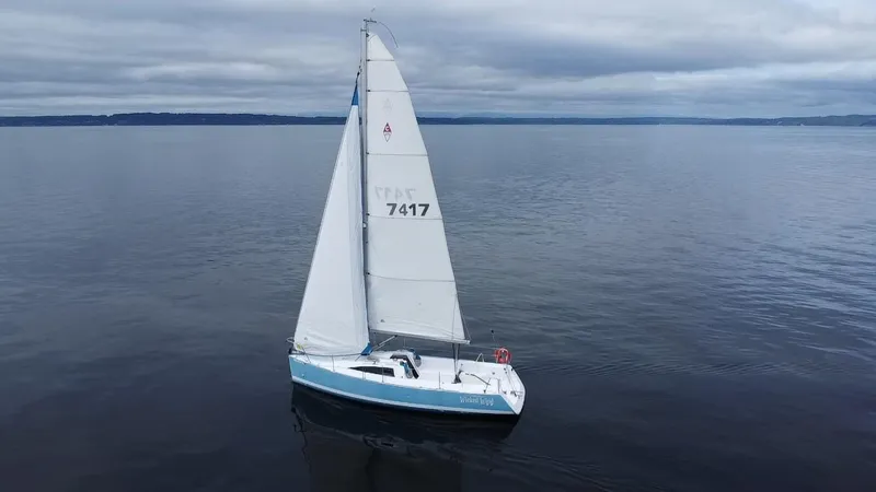 Slide: The Image of 2015 Catalina 275 Sport sailboat on calm waters under cloudy skies. - 12