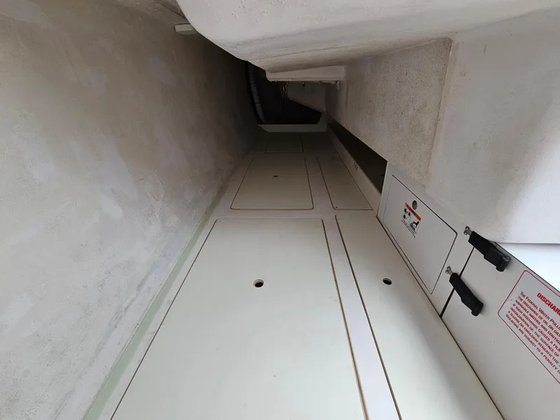 Slide: The Image of Interior view of a 2015 Catalina 275 Sport sailboat, showcasing storage compartments. - 9