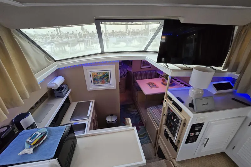 Slide: The Image of Interior of 1986 Silverton 34 Convertible Flybridge with modern amenities and cozy seating area. - 20
