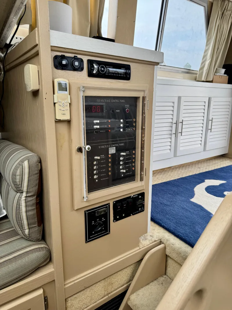 Slide: The Image of Control panel inside 1986 Silverton 34 Convertible Flybridge yacht, featuring electrical switches and seating. - 24