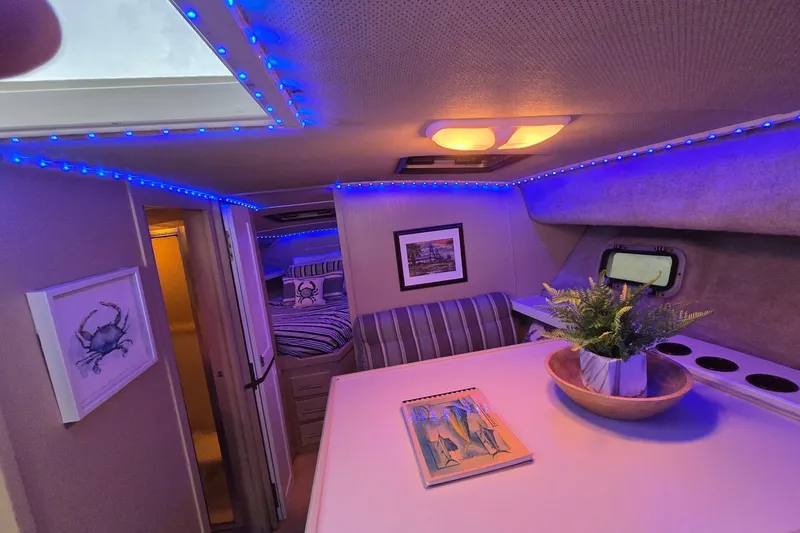 Slide: The Image of Interior of 1986 Silverton 34 Convertible Flybridge with blue LED lighting and nautical decor. - 26