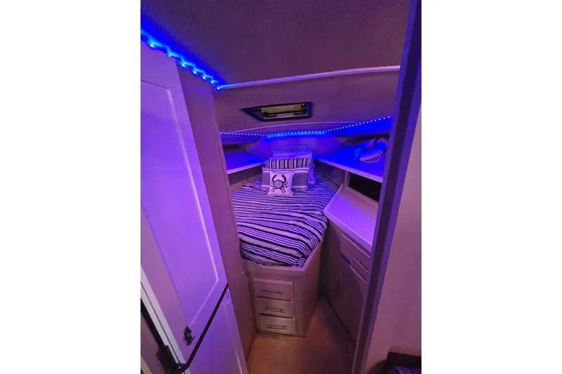 Slide: The Image of Cozy cabin interior of 1986 Silverton 34 Convertible Flybridge with blue LED lighting. - 28