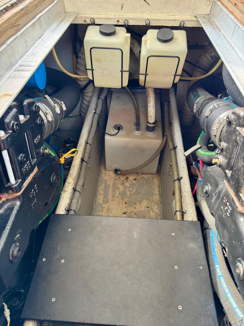 Slide: The Image of Engine compartment of a 1986 Silverton 34 Convertible Flybridge boat, showing tanks and mechanical components. - 31