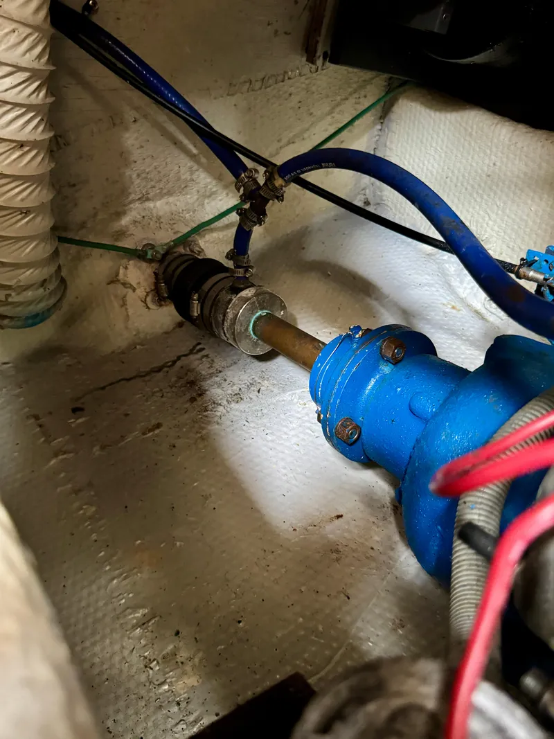 Slide: The Image of Engine compartment of 1986 Silverton 34 Convertible Flybridge with visible blue piping and connections. - 34