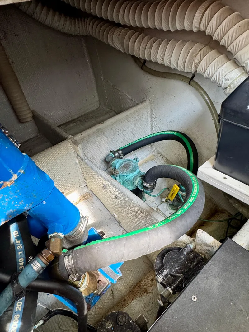 Slide: The Image of Engine compartment of a 1986 Silverton 34 Convertible Flybridge with visible hoses and components. - 37