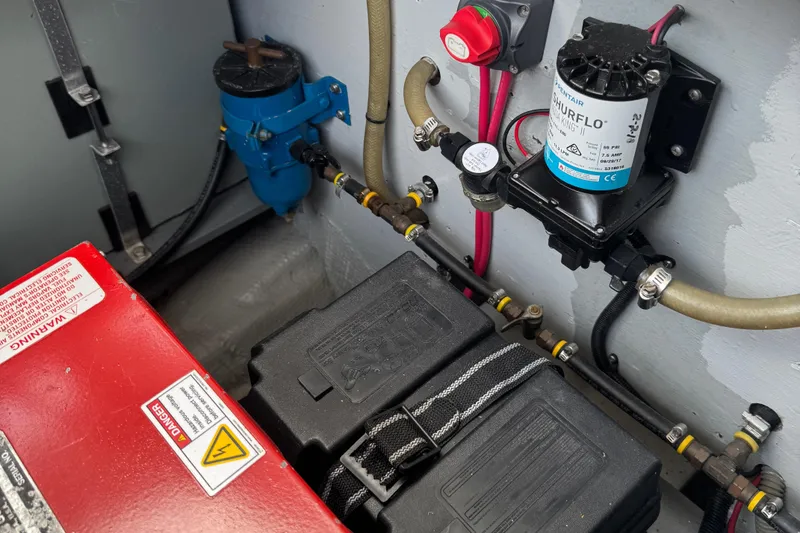 Slide: The Image of Engine compartment of 1986 Silverton 34 Convertible Flybridge with battery and pump system. - 39