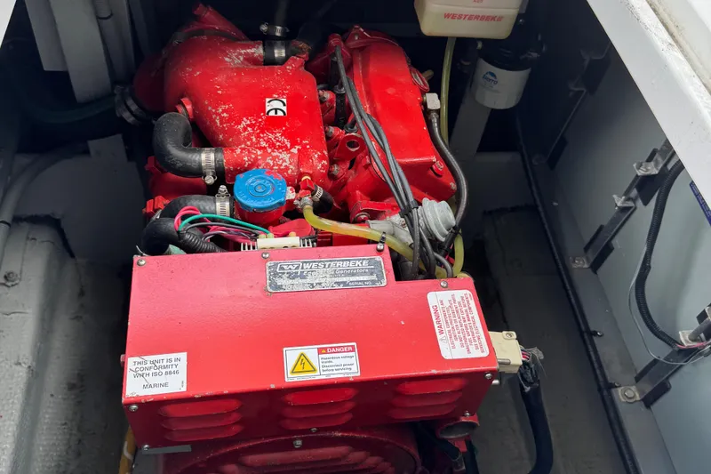 Slide: The Image of Engine compartment of a 1986 Silverton 34 Convertible Flybridge boat, featuring a red engine. - 40