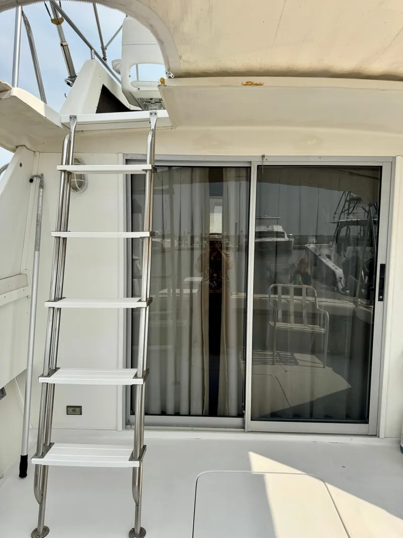 Slide: The Image of 1986 Silverton 34 Convertible Flybridge with ladder and sliding glass door. - 8