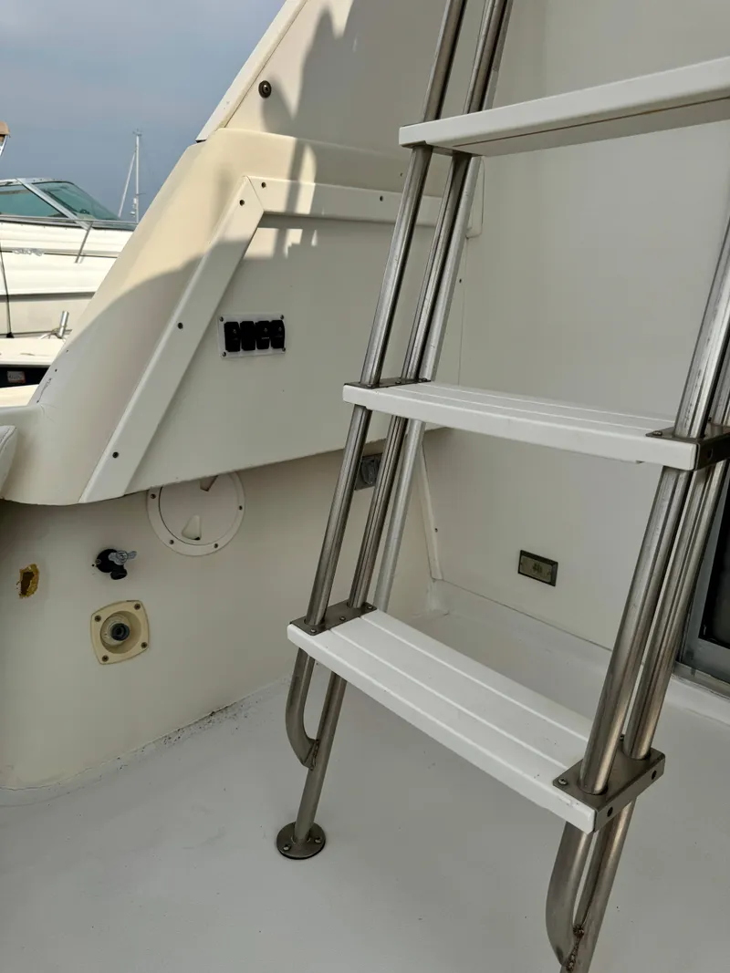 Slide: The Image of 1986 Silverton 34 Convertible Flybridge ladder and deck area. - 9