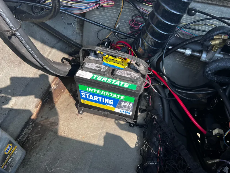 Slide: The Image of 2009 Glastron GT 185 boat battery compartment with Interstate starting battery. - 11