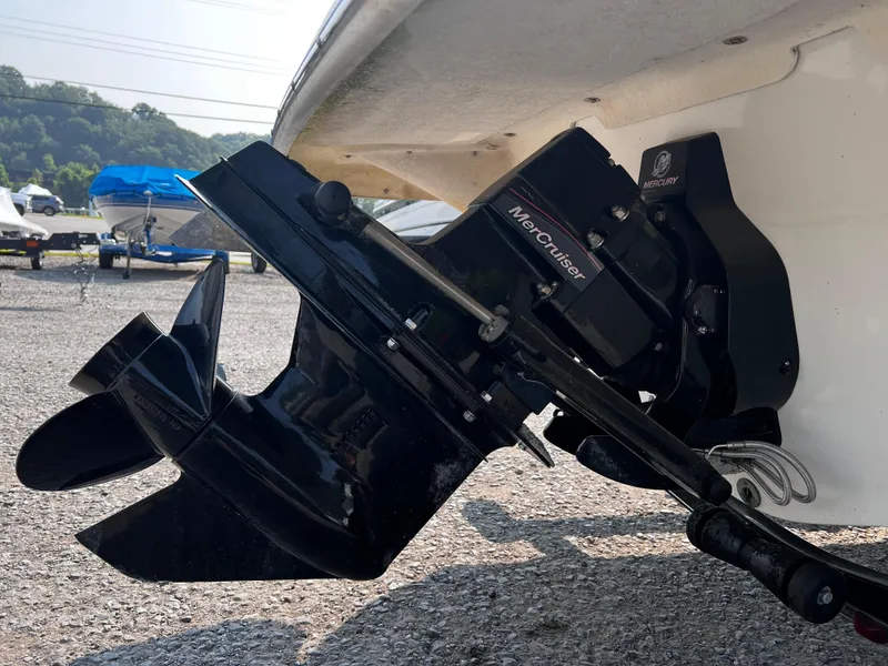 Slide: The Image of 2009 Glastron GT 185 boat with MerCruiser outboard motor, parked on gravel. - 12