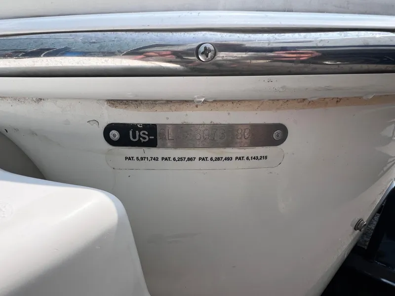 Slide: The Image of 2009 Glastron GT 185 boat hull identification number plate with patent details. - 13