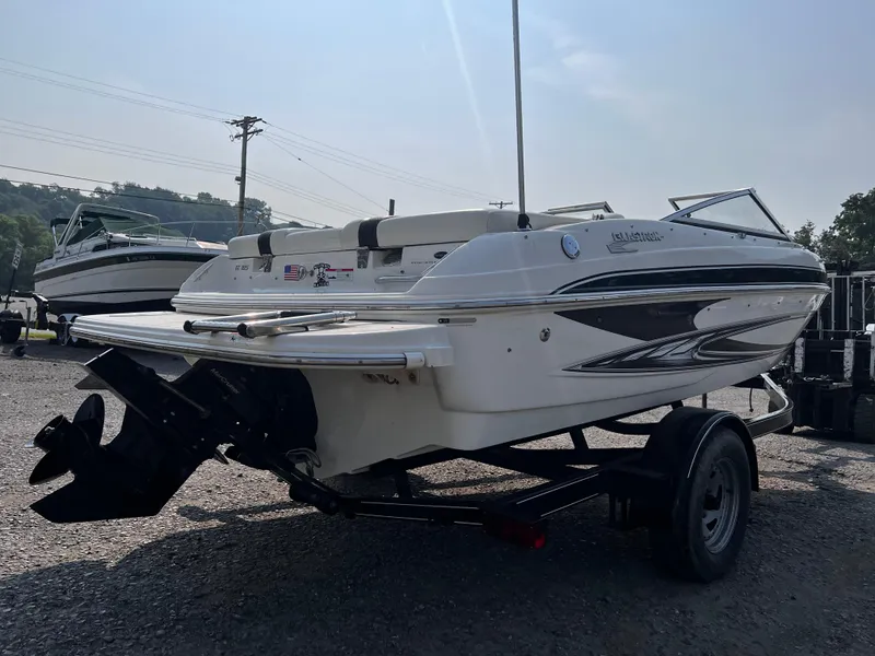 Slide: The Image of 2009 Glastron GT 185 boat on trailer, parked outdoors, rear view. - 2