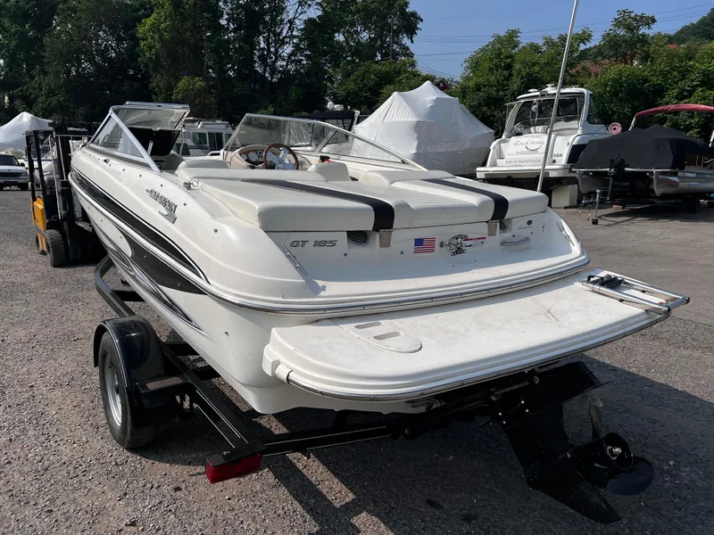 Slide: The Image of 2009 Glastron GT 185 boat on trailer, parked outdoors, rear view. - 3
