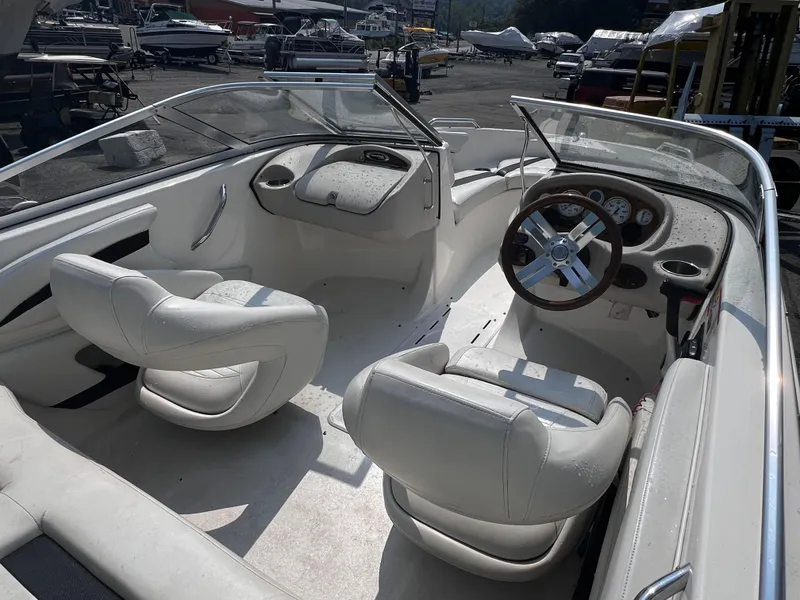 Slide: The Image of 2009 Glastron GT 185 boat interior with white seating and steering wheel. - 4