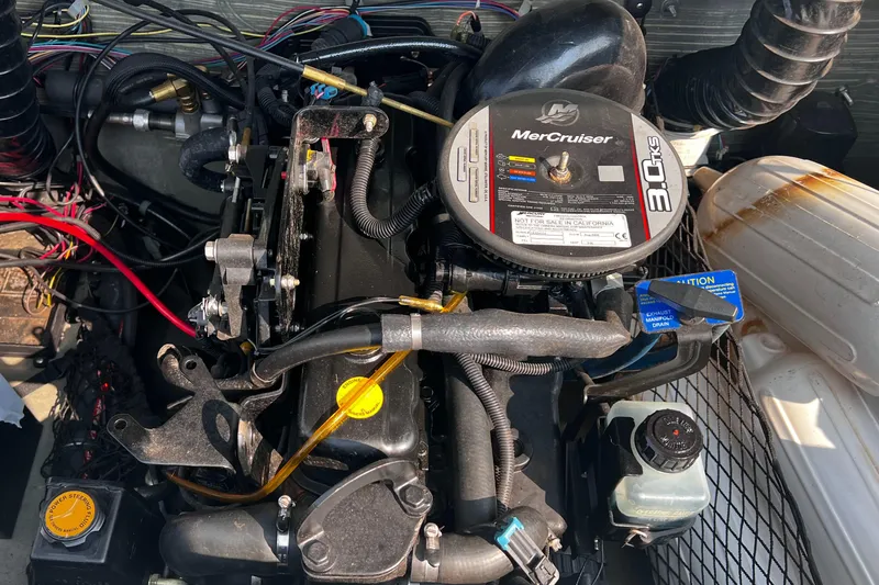 Slide: The Image of MerCruiser engine in a 2009 Glastron GT 185 boat, showcasing detailed components. - 9