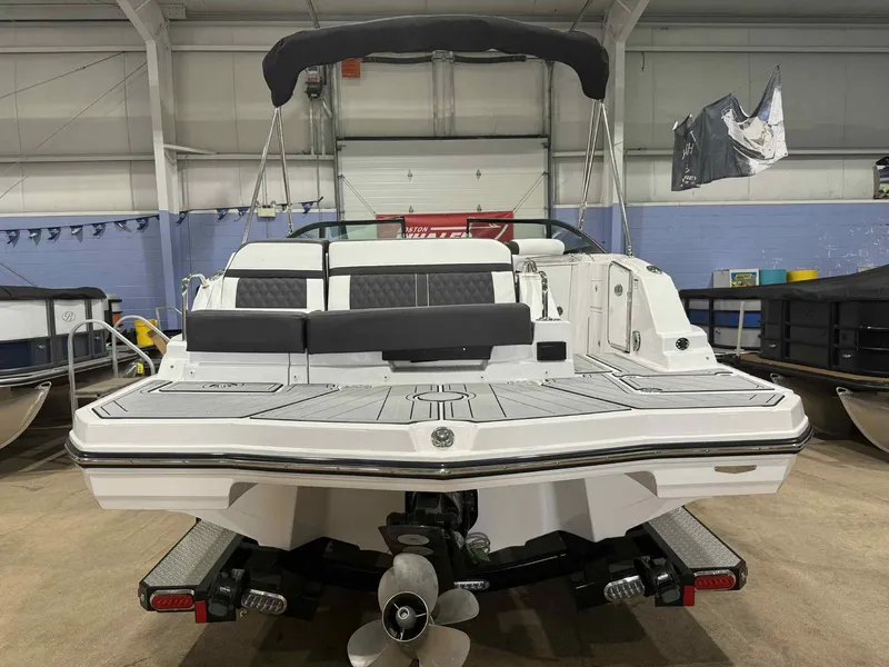 Slide: The Image of 2025 Monterey M4 boat in showroom, rear view with seating and propeller visible. - 3