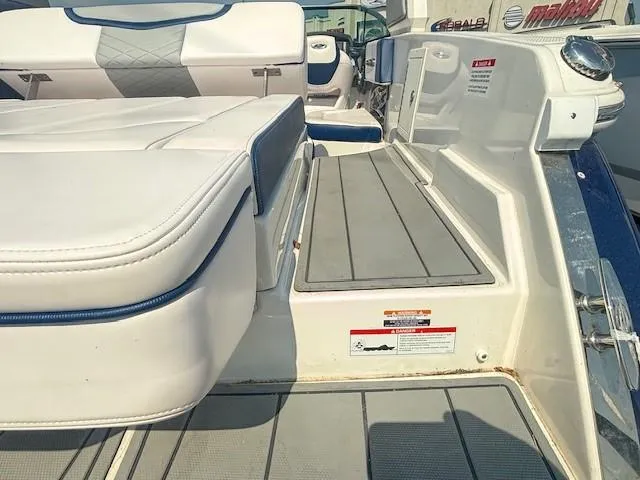 Slide: The Image of 2020 Chaparral 257 SSX boat interior with white and blue cushioned seating. - 10
