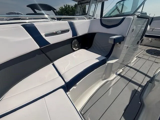 Slide: The Image of 2020 Chaparral 257 SSX boat interior with white seating and gray flooring. - 13