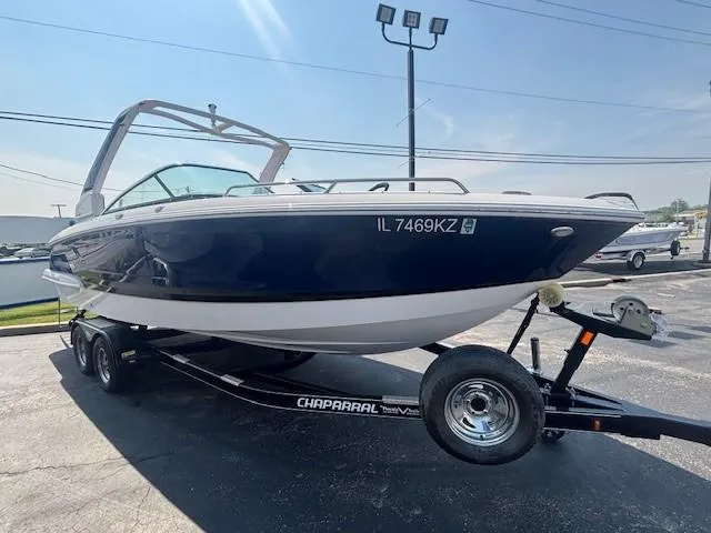 Slide: The Image of 2020 Chaparral 257 SSX boat on trailer, parked outdoors under clear sky. - 2