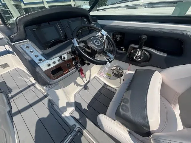 Slide: The Image of 2020 Chaparral 257 SSX boat on trailer, parked near McDonald's and Shell signs. - 3