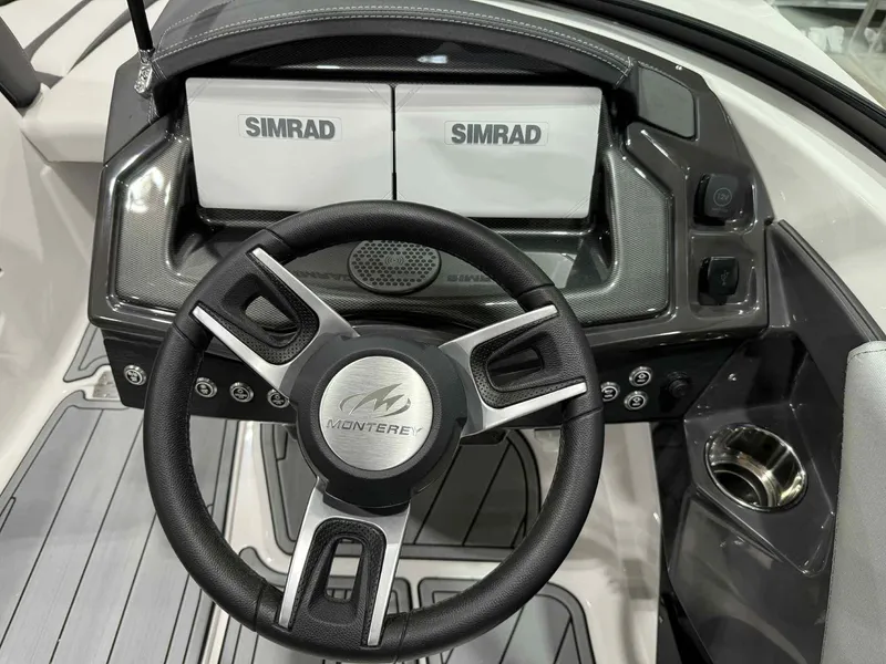 Slide: The Image of Steering wheel and dashboard of 2025 Monterey 218 SS boat with Simrad displays. - 10
