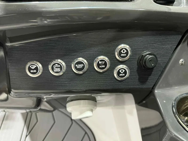 Slide: The Image of Control panel of 2025 Monterey 218 SS boat with various function buttons. - 12