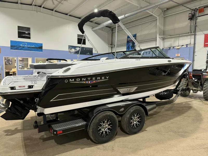 Slide: The Image of 2025 Monterey 218 SS boat on trailer in indoor showroom. - 2
