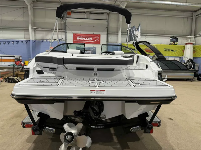 Slide: The Image of 2025 Monterey 218 SS boat in showroom, rear view with propeller and swim platform. - 3