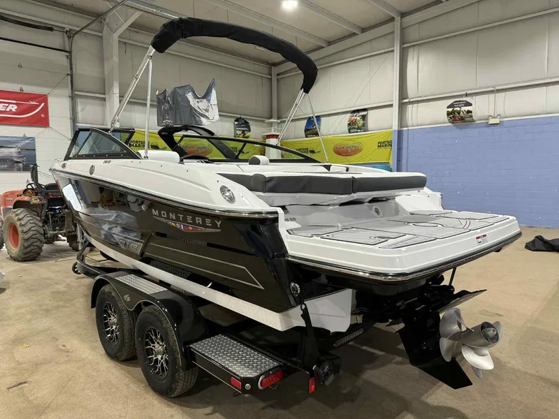 Slide: The Image of 2025 Monterey 218 SS boat on trailer in indoor showroom. - 4