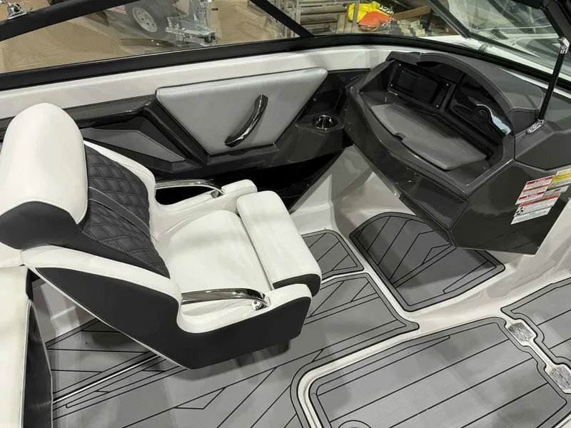 Slide: The Image of 2025 Monterey 218 SS boat interior with sleek black and white seating and modern dashboard. - 8