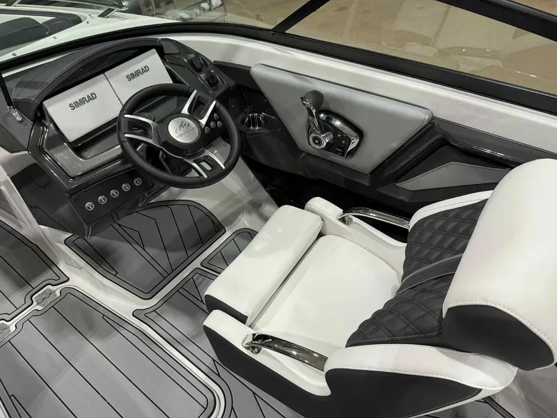 Slide: The Image of 2025 Monterey 218 SS boat interior with modern steering and dual Simrad displays. - 9