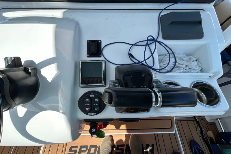 Slide: The Image of Control panel of a 2018 Sportsman 282 boat with steering wheel and navigation instruments. - 13