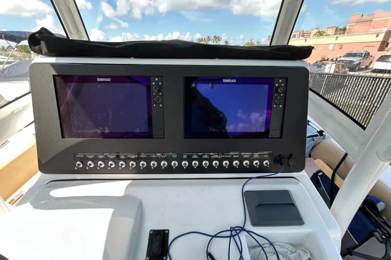 Slide: The Image of Control panel of a 2018 Sportsman 282 boat with dual Simrad displays. - 14