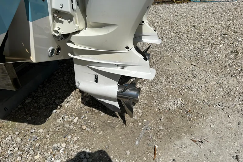 Slide: The Image of Outboard motor of a 2018 Sportsman 282 boat on gravel surface. - 20