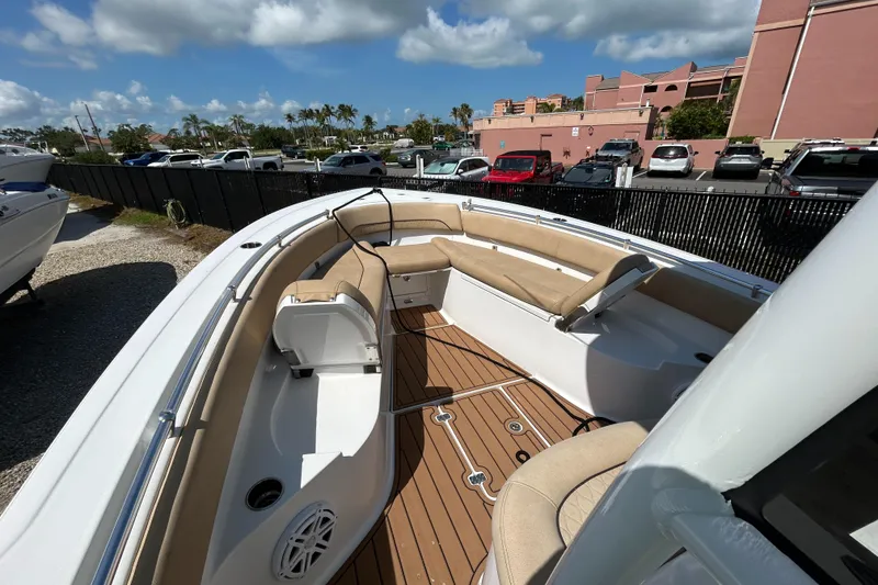 Slide: The Image of 2018 Sportsman 282 boat with spacious seating and sleek design in a marina setting. - 22