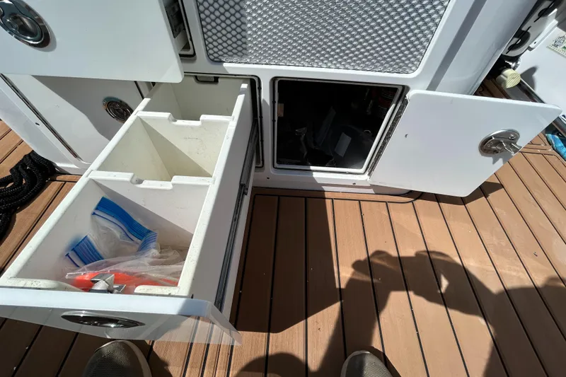 Slide: The Image of Open storage compartments on a 2018 Sportsman 282 boat deck. - 27