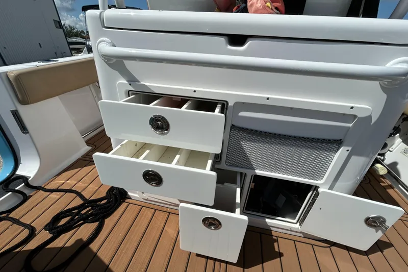 Slide: The Image of Open storage compartments on a 2018 Sportsman 282 boat deck. - 28