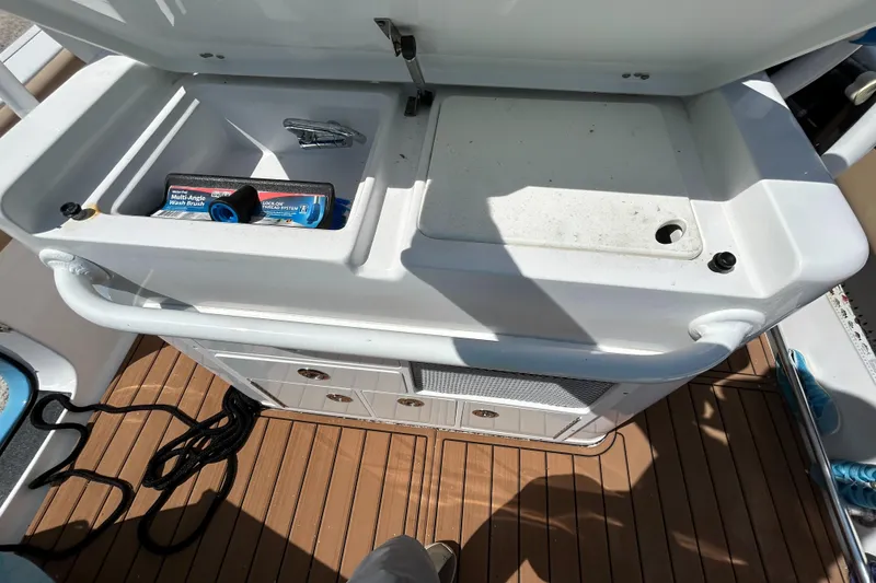 Slide: The Image of 2018 Sportsman 282 boat deck with storage compartments and wooden flooring. - 29