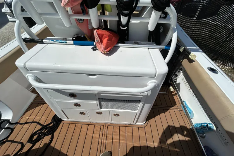 Slide: The Image of 2018 Sportsman 282 boat deck with storage compartments and fishing gear. - 30