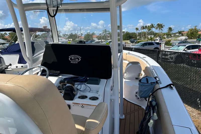 Slide: The Image of 2018 Sportsman 282 boat interior with helm, seating, and equipment under a clear blue sky. - 31
