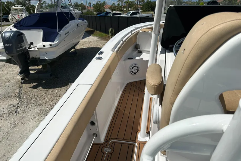 Slide: The Image of 2018 Sportsman 282 boat interior with tan seating and wood flooring. - 7