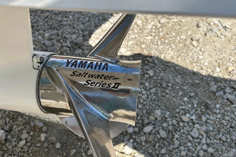 Slide: The Image of Yamaha Saltwater Series II propeller on Sportsman 282, 2018 model, on gravel surface. - 9
