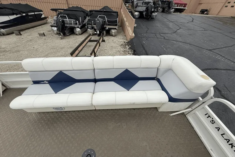 Slide: The Image of 2005 Bentley Pontoons 240 CRUISE boat seating, white and blue upholstery, docked at marina. - 3