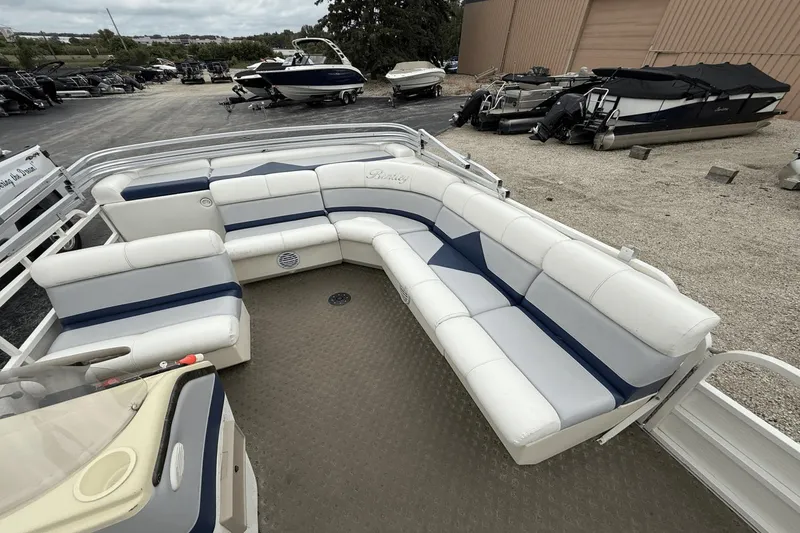 Slide: The Image of 2005 Bentley Pontoons 240 CRUISE with spacious seating, parked outdoors. - 4