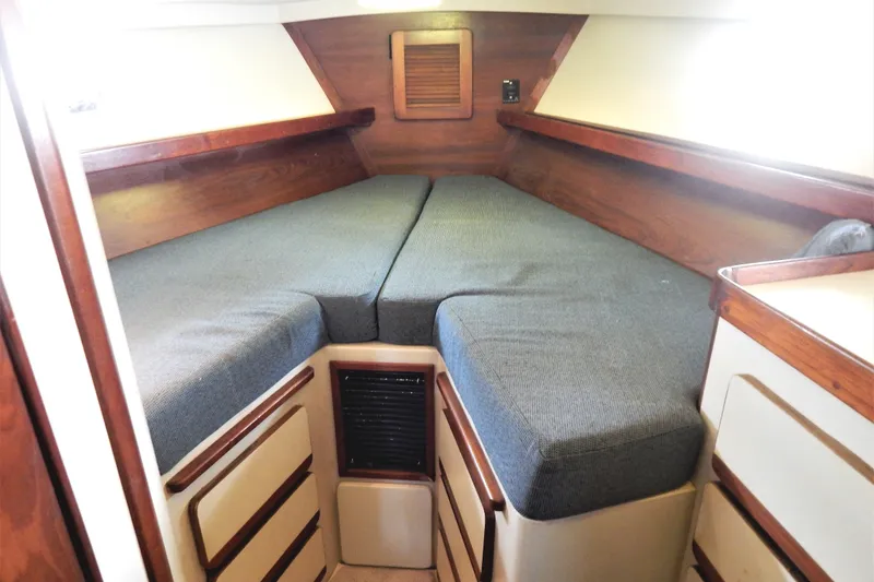 Slide: The Image of Cozy cabin interior of 1986 Irwin 43 Mk II Cruiser with twin beds and wooden accents. - 12