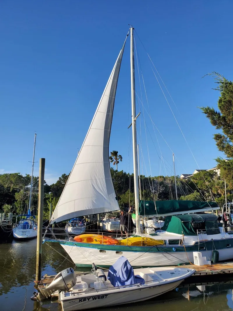 Slide: The Image of 1986 Irwin 43 Mk II Cruiser sailboat docked in a sunny marina. - 17