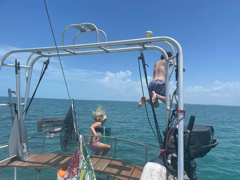 Slide: The Image of Children playing on an Irwin 43 Mk II Cruiser sailboat, 1986, in the ocean. - 19